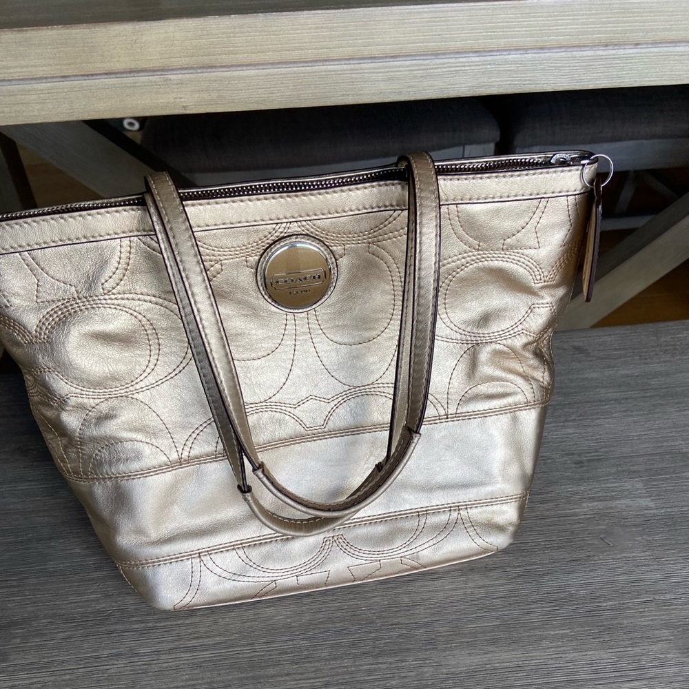 Coach purse. Gold leather w/ stitched C. Excellent condition